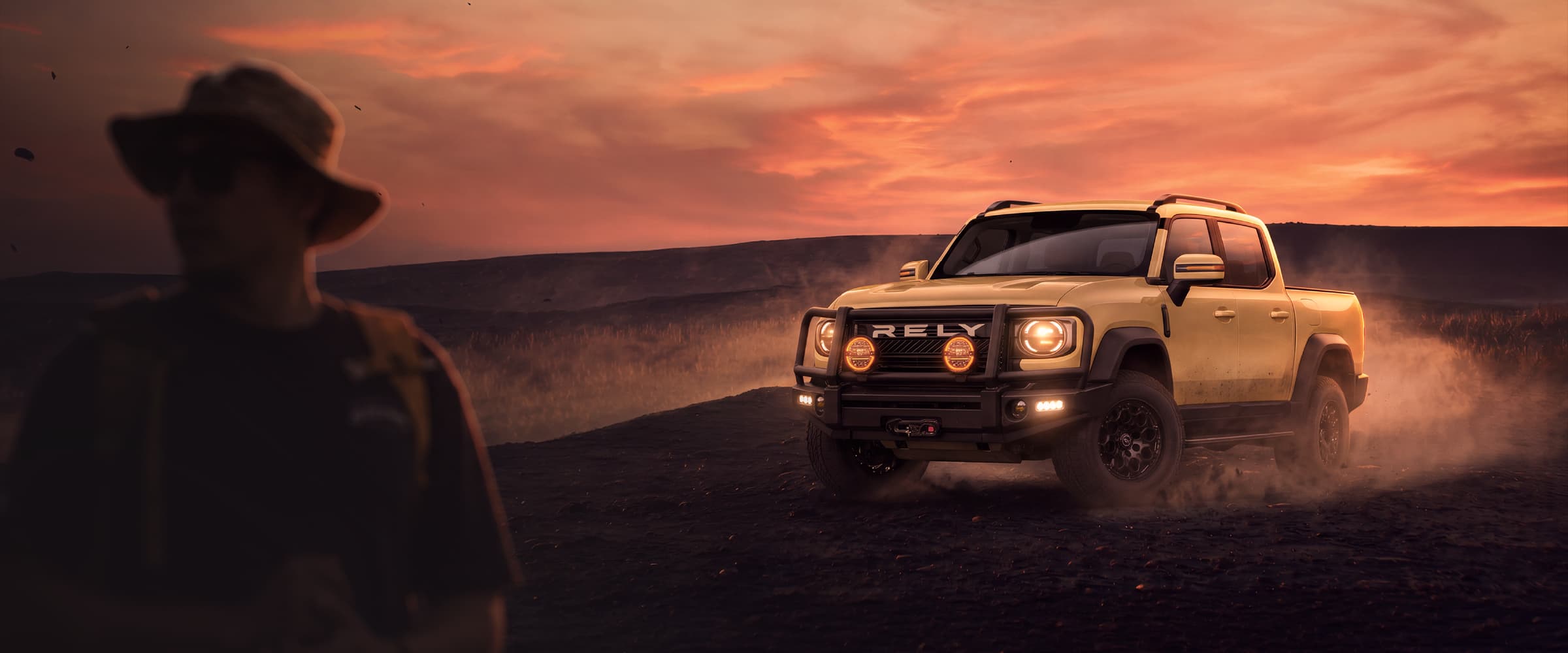 Off-road pickup on a dusty trail at sunset