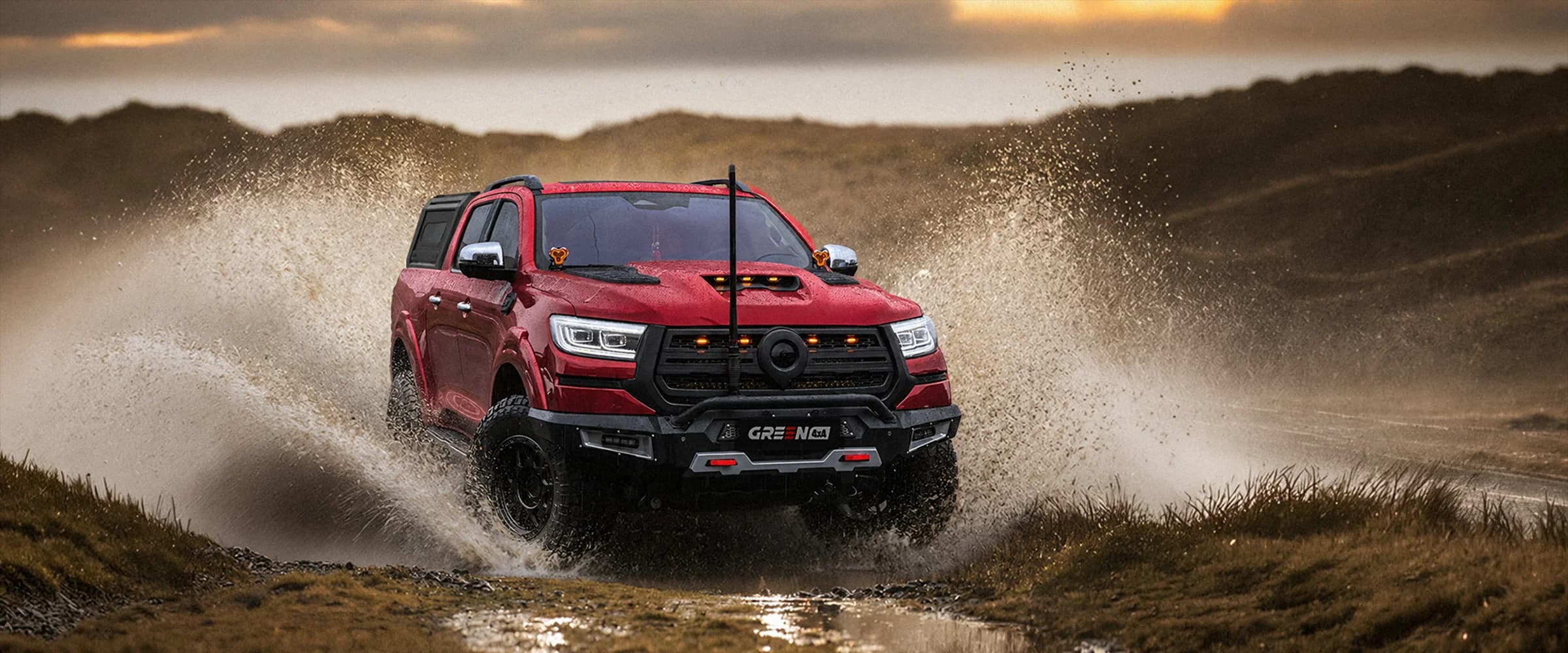 Red off-road pickup splashing through water